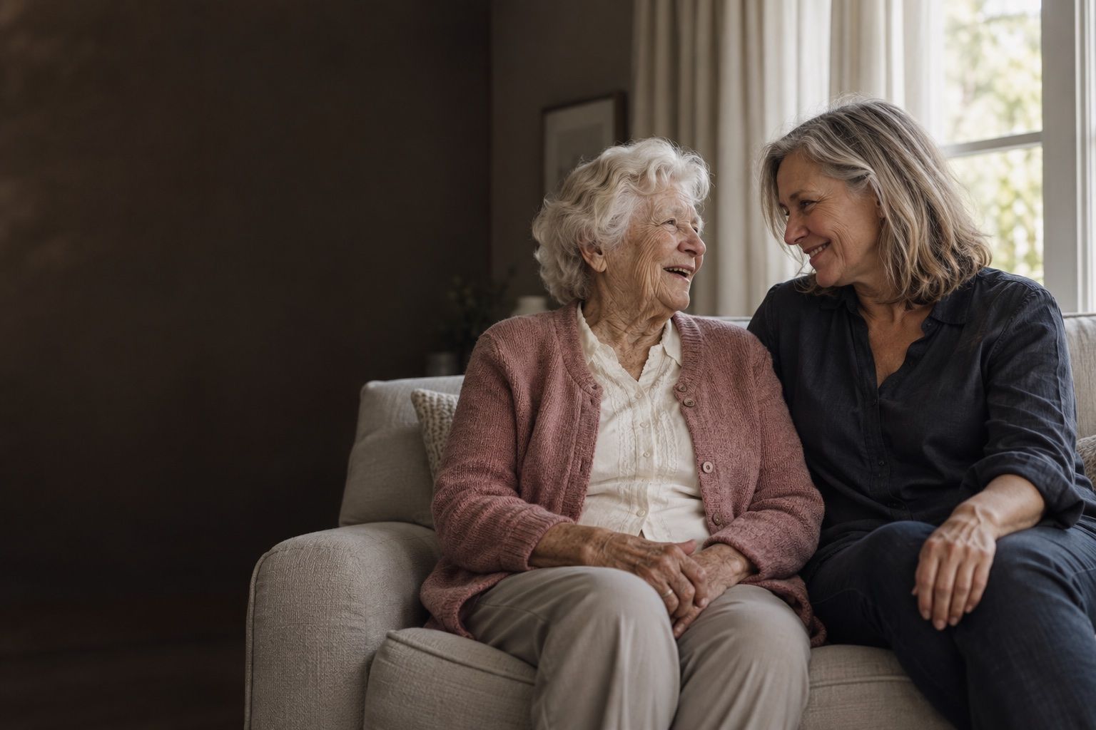 A daughter and her mother sitting together at home